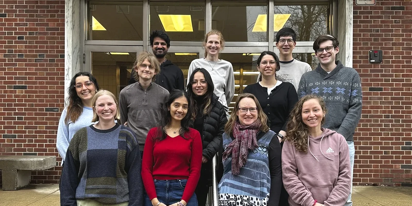 Jay with members of Prof. Helvi Witek’s Gravity Group outside a brick building at Illinois