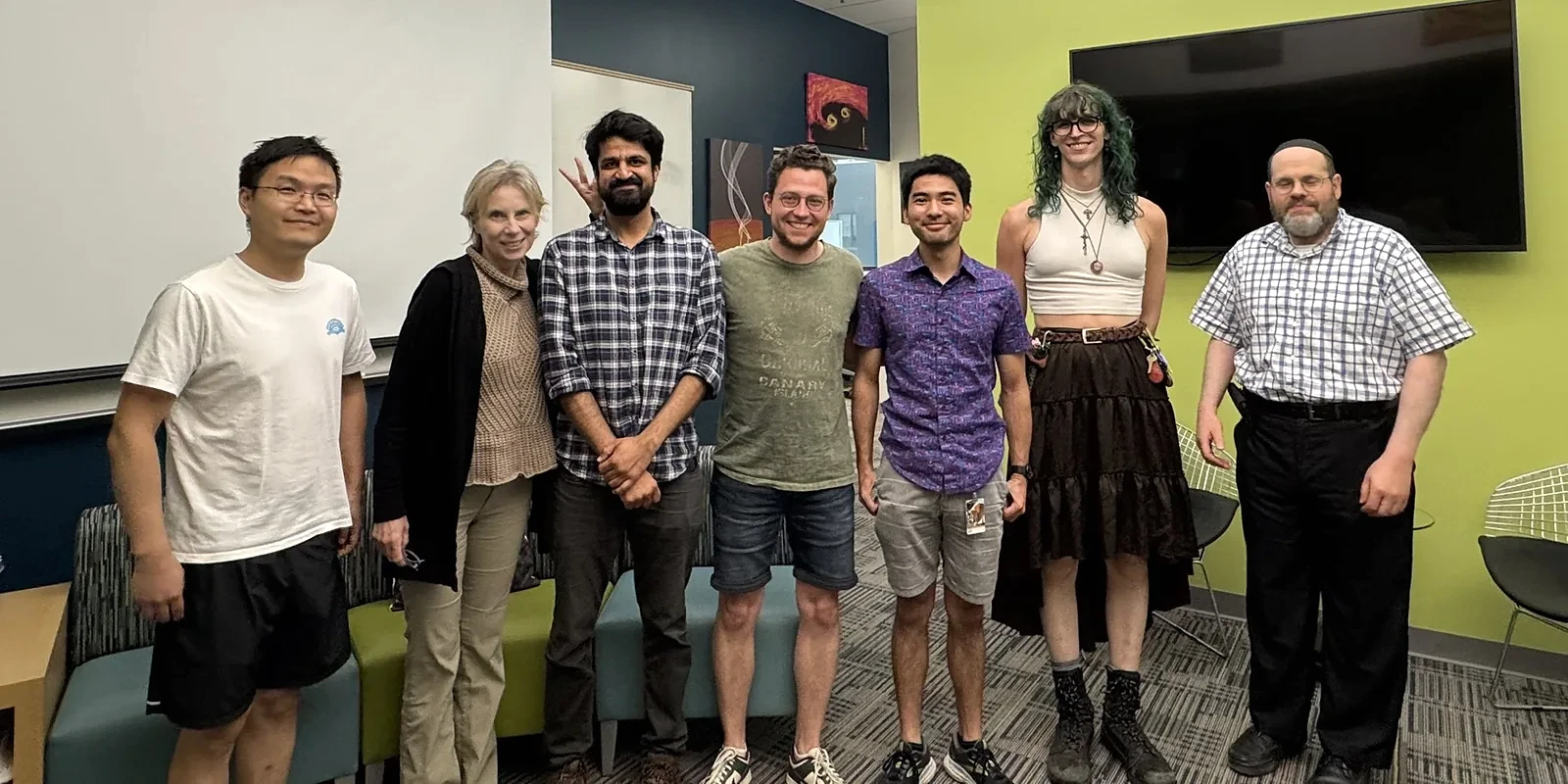 Jay with members of Prof. Manuela Campanelli’s research group in a meeting room at RIT